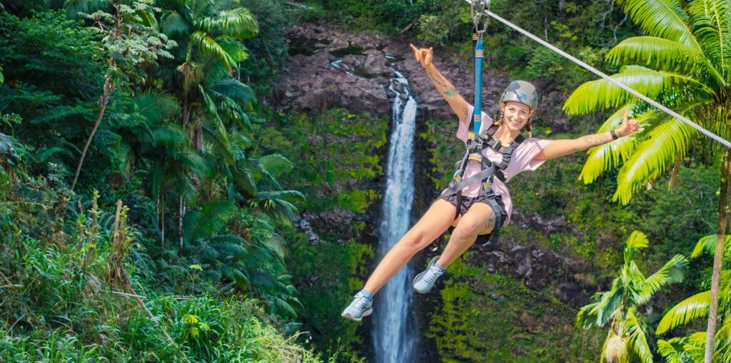 Aerial view of Kolekole Falls waterfall surrounded by lush Hawaiian jungle