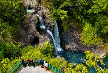 Group of guests on a viewing platform overlooking Kolekole Falls waterfall